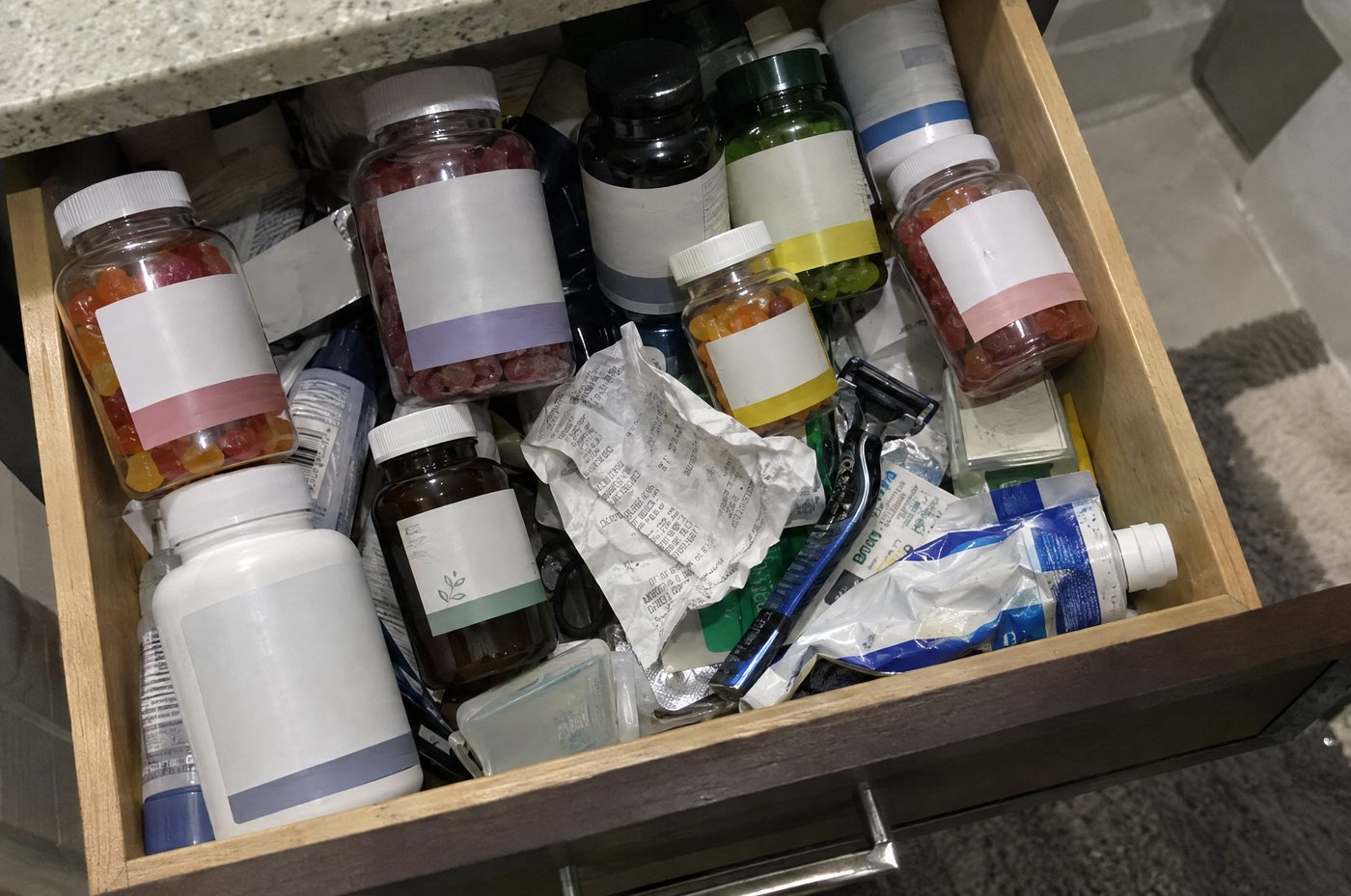 A bathroom drawer crammed with half-used male enhancement supplement bottles